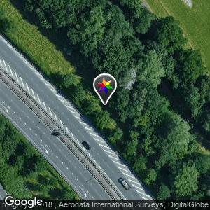 In the green zone along the bicycle path